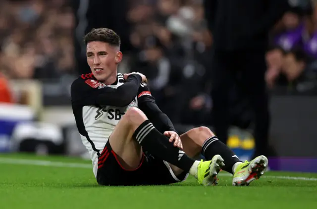 Harry WIlson goes down holding his shoulder.