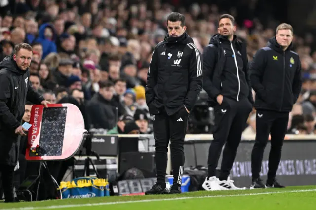 Marco Silva stands with his hands on his pockets on the sideline.