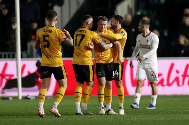 Newport players celebrate scoring against Manchester United