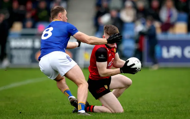 Wicklow's Dean Healy challenges Down's Odhran Murdock in Aughrim