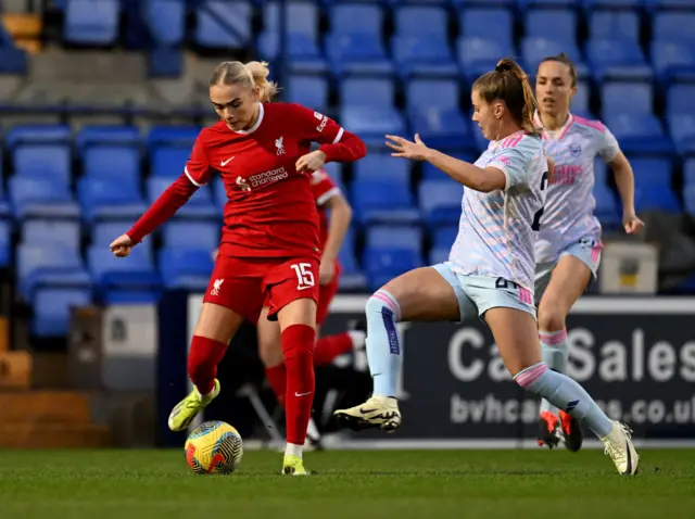 Lundgaard tries to play the ball as Pelova closes down.