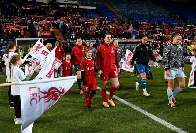 The players make their way out onto the pitch before kick off.