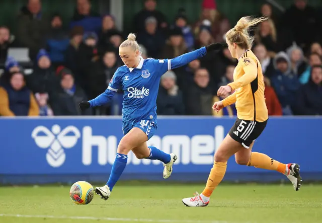 Bennison takes aim at goal as Howard looks to cover.