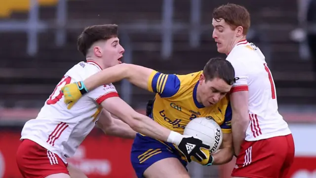 Peter Harte and Niall Devlin tackle Roscommon's David Murray at Healy Park