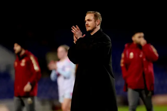 Jonas Eidevall claps the travelling fans from the pitch at full time.