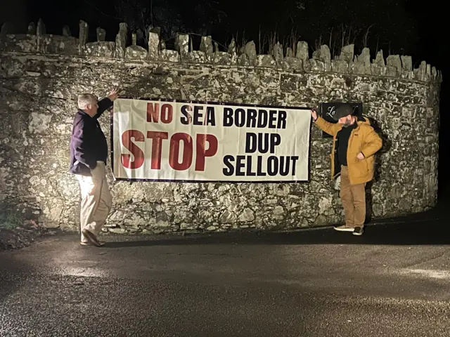 TUV protesters with a sign saying "No Sea Border STOP DUP Sellout"