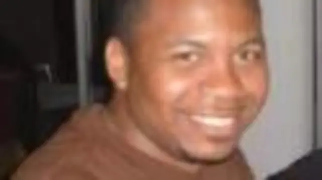 Sgt. William J. Rivers seen wearing a brown t-shirt and smiling into the camera