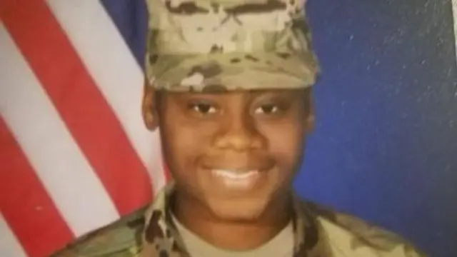 Spc. Breonna A. Moffett seen wearing her army uniform and smiling into the camera.