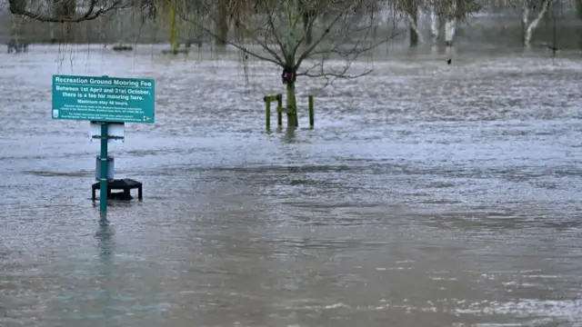 Flood water from the River Avon surrounds a sign in Stratford-upon-Avon