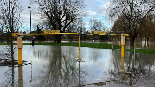 The River Great Ouse overflowing into a car park in St Neots, Cambridgeshire