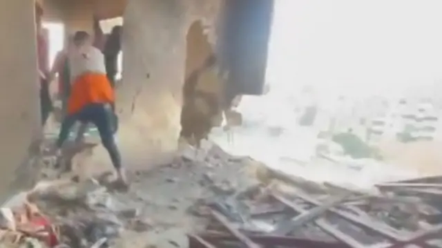 Rescuers in a damaged Palestinian Red Crescent building in Khan Younis, southern Gaza