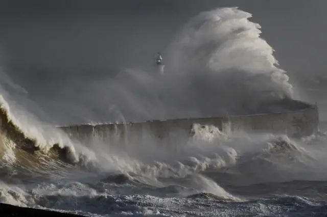 Waves crash on the breakwater at Newhaven Harbour, East Sussex, on Tuesday