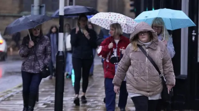 People walk in the rain in York, Yorkshire.