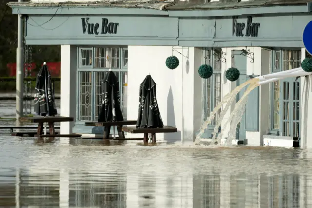 Flood water is pumped from the Vue Bar after the River Severn burst its banks