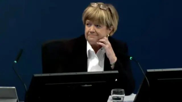 Covid inquiry chair Lady Hallett rests her head on her hand and looks at John Swinney