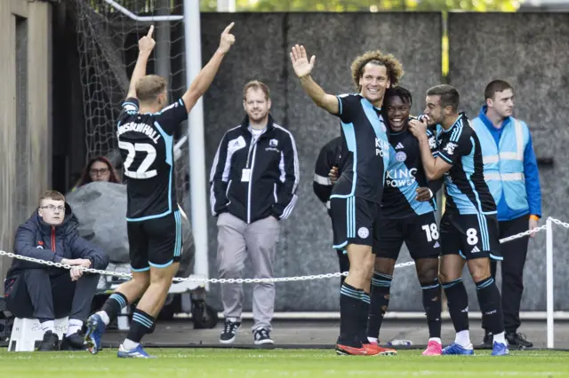 Leicester players celebrate a goal at Swansea