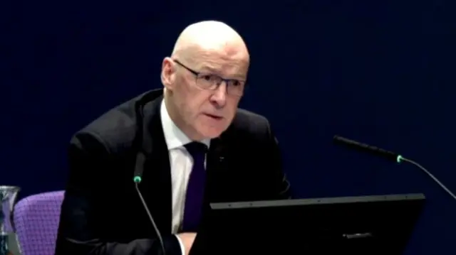 John Swinney gives evidence to Covid inquiry, wearing a black suit