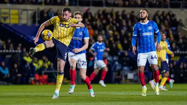 Oxford United defender Elliott Moore clears the ball