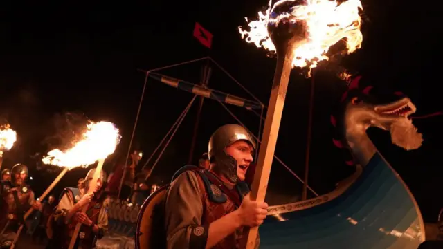 Viking galley surrounded by torch bearers at Up Helly Aa