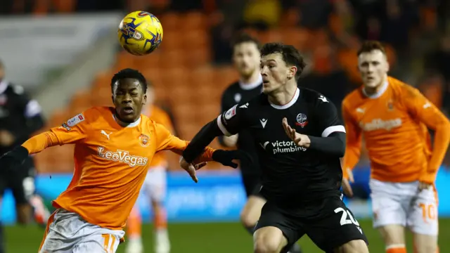 Karamoko Dembele of Blackpool battles for the ball with Calvin Ramsay of Bolton Wanderers