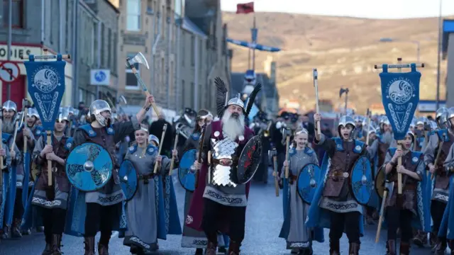 Guizer Jarl Richard Moar leads the parade through Lerwick, wearing Viking clothes