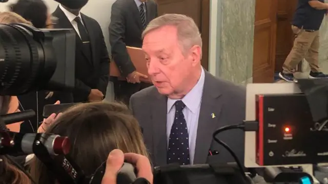 Durbin speaks to reporters outside the hearing room