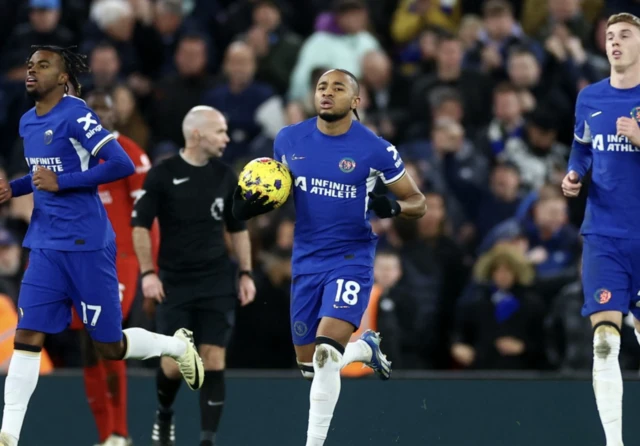 Christopher Nkunku runs back after scoring ball in hand