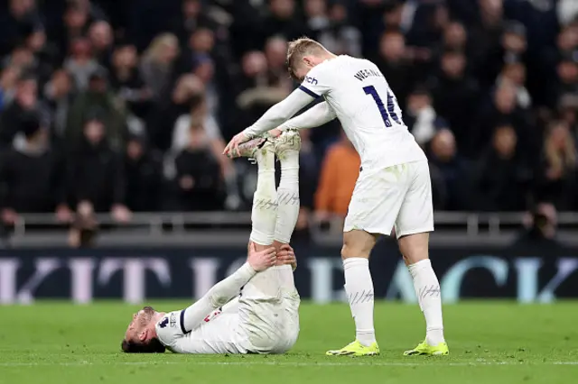 ames Maddison of Tottenham Hotspur receives treatment from Timo Werner