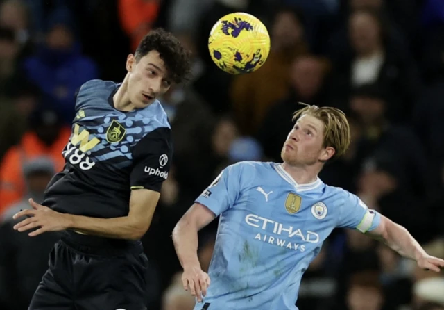 Kevin De Bruyne in action with Burnley's Ameen Al-Dakhil