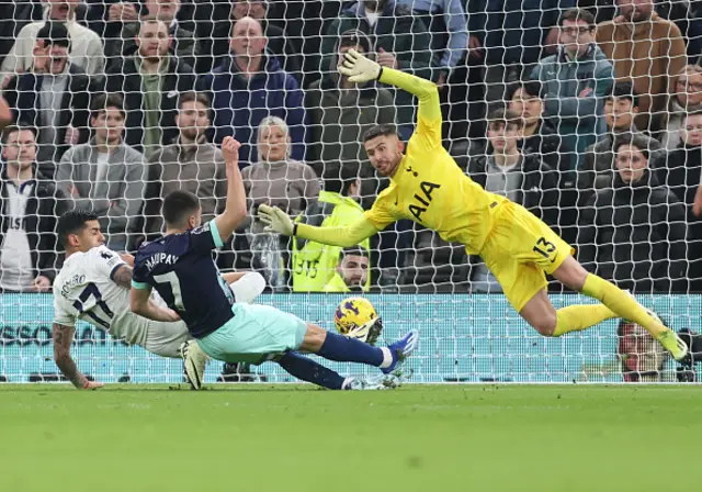 Neal Maupay shoots as Romero attempts to block