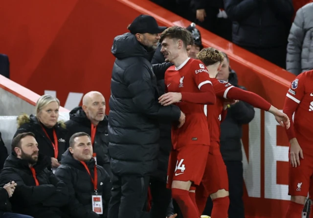 Jurgen Klopp and Conor Bradley embrace each other