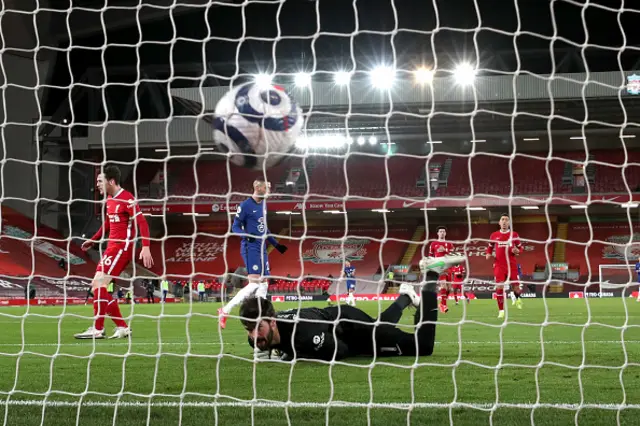 Alisson of Liverpool looks on at the ball after conceding