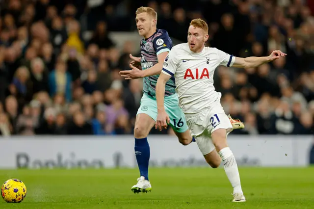 Dejan Kulusevski of Tottenham Hotspur and Ben Mee of Brenford challenge