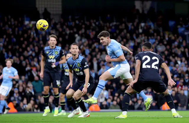 Julian Alvarez heads the ball into the net