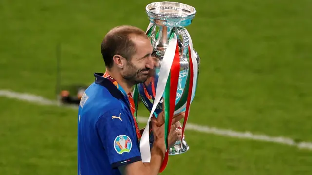 Italy's Giorgio Chiellini celebrates with the trophy after winning Euro 2020