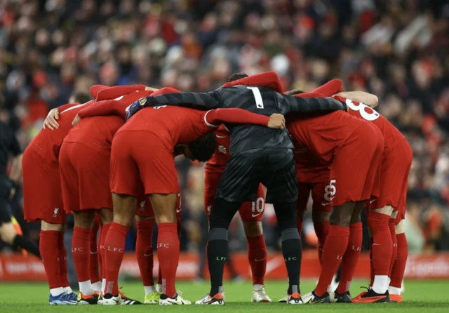 Liverpool players in a huddle before the match