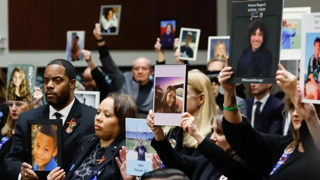 People hold up photographs and placards during the Senate Judiciary Committee hearing on online child sexual exploitation at the U.S. Capitol