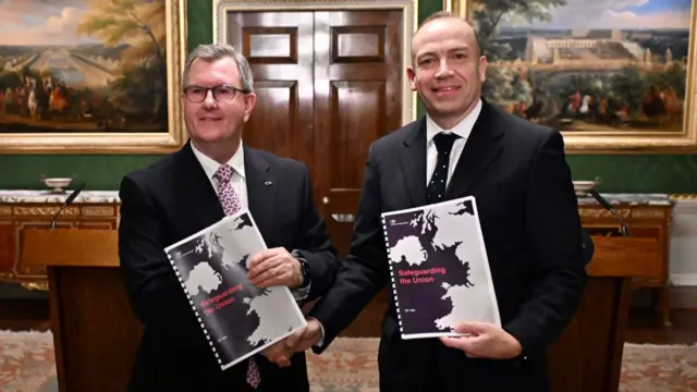 Democratic Unionist Party (DUP) leader, Sir Jeffrey Donaldson (L) and Northern Ireland Secretary, Chris Heaton-Harris (R) pose after speaking to the media on January 31, 2024