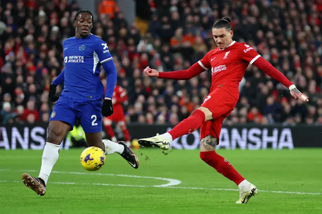 : Darwin Nunez of Liverpool shoots whilst under pressure from Axel Disasi