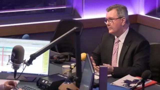 DUP leader Sir Jeffrey Donaldson sitting in a radio studio