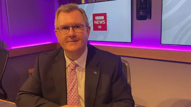 Sir Jeffrey Donaldson sitting in a radio studio