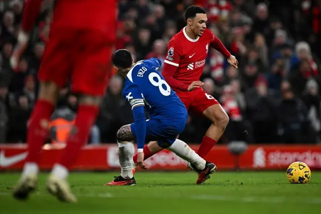 Trent Alexander-Arnold fights for the ball withEnzo Fernandez