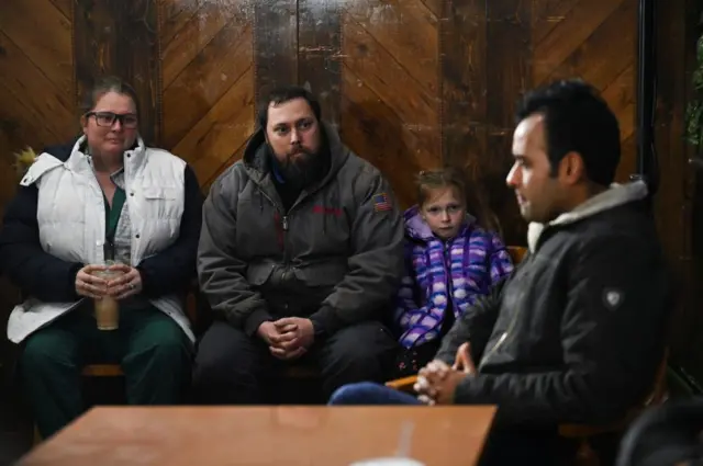 Candidate Vivek Ramaswamy (right) speaks to parents from Perry after the shooting attack