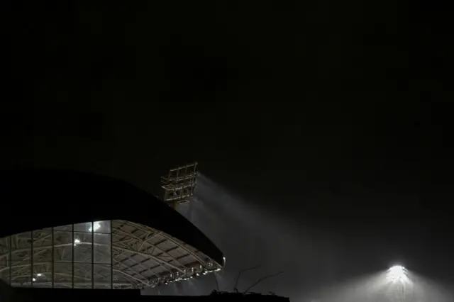 Rain swirls around the roof of the stadium.