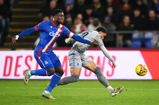 Danjuma shoots under pressure from a Palace defender.