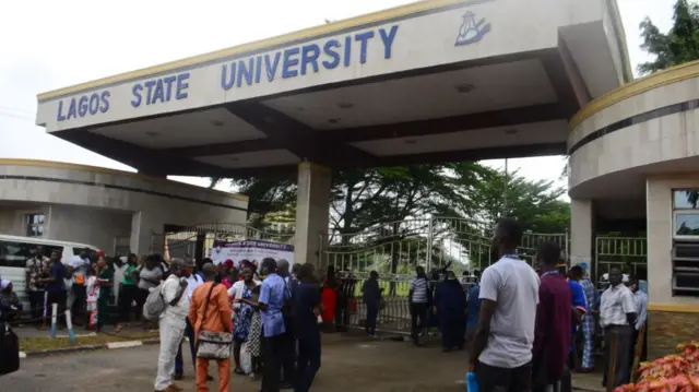 Students and lecturers of Lagos State University wait out the school gate as The Academic Staff Union of Universities (ASUU), Nigerian Labour Congress (NLC) and the Non-Academic Staff Union of Universities (NASU) prevent them from gaining entrance into the school premises, over the payment of the minimum wage Lagos, on September, 2020.