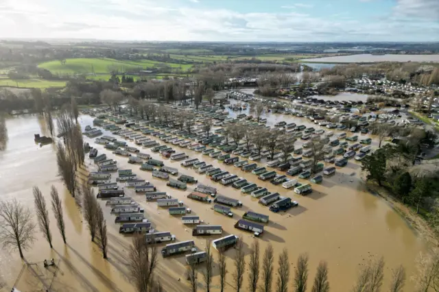 Holiday homes at the Billing Aquadrome in Northampton surrounded by water due to rising water caused by Storm Henk