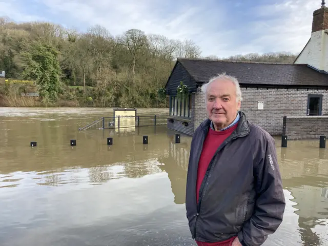 Nigel Venn outside the flooded Half Moon Inn