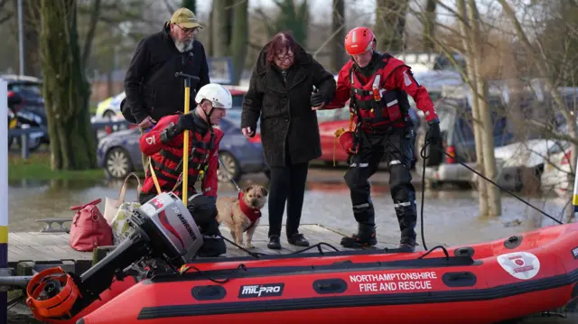 A woman is rescued during flooding at Billing Aquadrome in Northampton