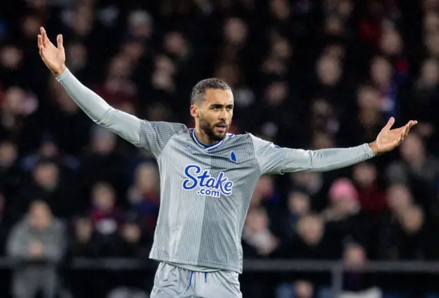 Calvert-Lewin raises his arms in frustration.